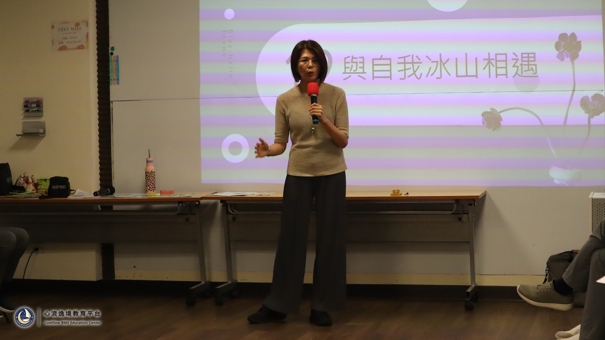 Portrait of a young businesswoman hugging herself Young woman wearing blue shirt embracing herself and smiling. Studio shot on grey background. embrace yourself stock pictures, royalty-free photos & images